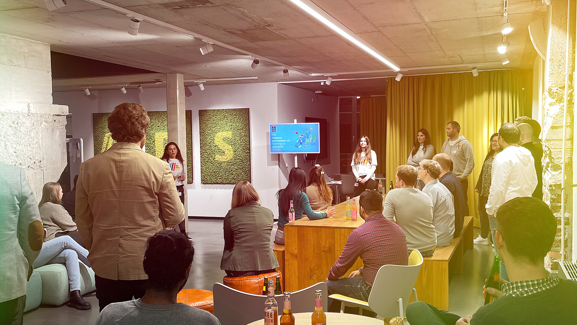 Menschen bei Afterwork-Event von ALDI DX in entspannter Atmosphäre.